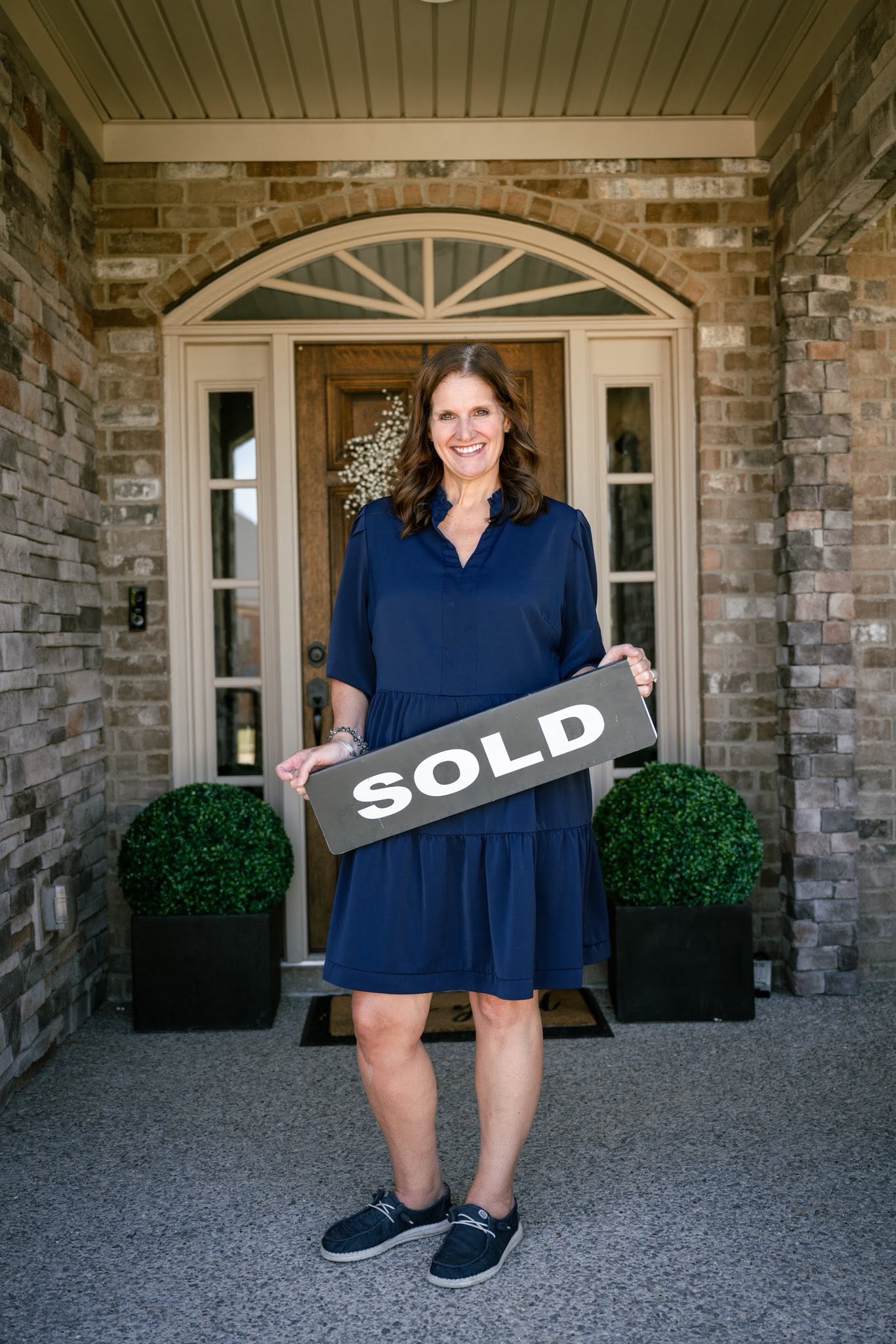 LeeAnn Kampfer with a sold sign